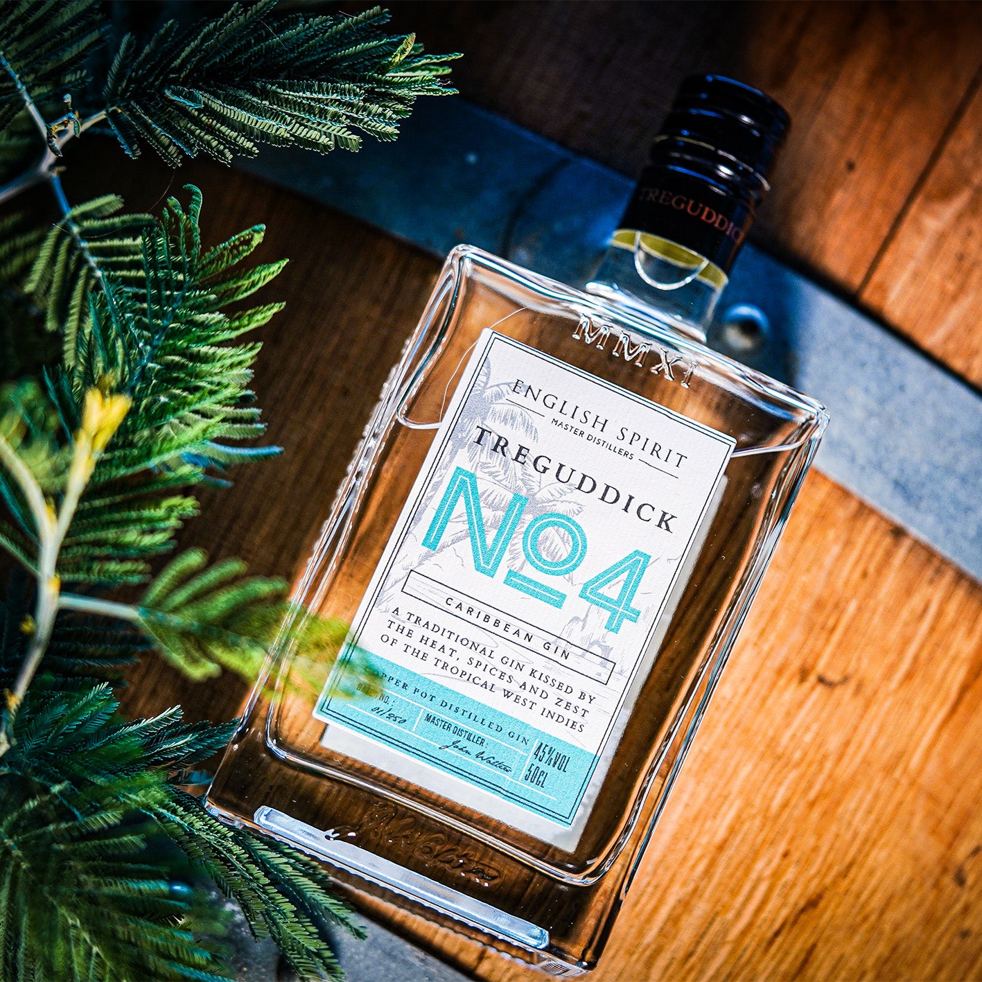 Treguddick No.4 Caribbean Gin - 50cl bottle. Featuring a bottle with tropical motifs, set against a backdrop of tropical fruit.